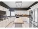 Kitchen featuring an island, stainless steel appliances, and white cabinetry at 1388 Brightwaters Ne Blvd, St Petersburg, FL 33704