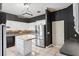 Traditional-style kitchen features white cabinetry, tiled flooring, and stainless steel appliances at 1388 Brightwaters Ne Blvd, St Petersburg, FL 33704