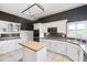 Well-equipped kitchen with white cabinetry, an island, and built-in appliances at 1388 Brightwaters Ne Blvd, St Petersburg, FL 33704
