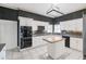 Kitchen with built in oven, cooktop, island, and white cabinetry at 1388 Brightwaters Ne Blvd, St Petersburg, FL 33704
