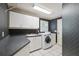 Laundry room with modern washer/dryer, white cabinets and countertop space at 1388 Brightwaters Ne Blvd, St Petersburg, FL 33704