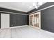 Bright living room with tiled flooring, accent wallpaper, and french doors at 1388 Brightwaters Ne Blvd, St Petersburg, FL 33704
