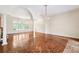 Spacious living room with parquet floors, arched windows, and chandelier at 1388 Brightwaters Ne Blvd, St Petersburg, FL 33704