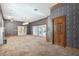 Spacious carpeted living room with a fireplace, built-in bar and doors to outside at 1388 Brightwaters Ne Blvd, St Petersburg, FL 33704