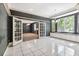 Bright living room with bay window, built-in storage, and glass french doors at 1388 Brightwaters Ne Blvd, St Petersburg, FL 33704