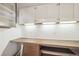 Dedicated office space featuring a custom built-in desk and storage area with bright lighting at 1388 Brightwaters Ne Blvd, St Petersburg, FL 33704