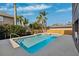 Refreshing blue swimming pool with a spa, surrounded by lush landscaping at 1388 Brightwaters Ne Blvd, St Petersburg, FL 33704