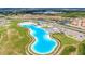 Aerial view of resort-style pool with expansive sandy beach and surrounding community at 16820 Anchor Root St, Wimauma, FL 33598