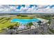 Aerial view of a resort-style lagoon pool and community at 16820 Anchor Root St, Wimauma, FL 33598