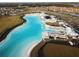 Aerial view of lagoon pool, sandy beach, and amenities at 16820 Anchor Root St, Wimauma, FL 33598