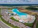 Aerial view of expansive lagoon pool and surrounding area at 16820 Anchor Root St, Wimauma, FL 33598