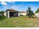 Landscaped backyard with covered patio and lawn at 16820 Anchor Root St, Wimauma, FL 33598