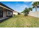 Spacious backyard with grassy lawn and screened patio at 16820 Anchor Root St, Wimauma, FL 33598