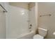Clean bathroom with a tub, toilet, and shower at 16820 Anchor Root St, Wimauma, FL 33598