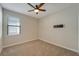 Spacious bedroom with ceiling fan and neutral carpeting at 16820 Anchor Root St, Wimauma, FL 33598
