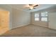 Bedroom with carpet flooring, ceiling fan, and two windows at 16820 Anchor Root St, Wimauma, FL 33598