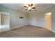 Bright bedroom featuring carpet flooring and access to a bathroom at 16820 Anchor Root St, Wimauma, FL 33598