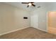 Bedroom with ceiling fan, neutral walls, and double doors to closet at 16820 Anchor Root St, Wimauma, FL 33598