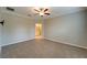 Spacious bedroom with carpet, ceiling fan, and ensuite bathroom at 16820 Anchor Root St, Wimauma, FL 33598