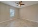 Simple bedroom with tile floors and a ceiling fan at 16820 Anchor Root St, Wimauma, FL 33598