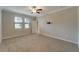 Spacious bedroom with neutral walls, carpet, and large windows at 16820 Anchor Root St, Wimauma, FL 33598