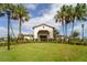Medley community clubhouse with palm trees and landscaping at 16820 Anchor Root St, Wimauma, FL 33598