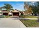 House exterior view showcasing a driveway and landscaping at 16820 Anchor Root St, Wimauma, FL 33598