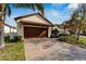 House exterior showcasing a garage and well-maintained landscaping at 16820 Anchor Root St, Wimauma, FL 33598