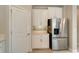 Stainless steel refrigerator and white cabinets are featured in this kitchen at 16820 Anchor Root St, Wimauma, FL 33598
