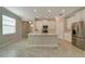 Modern kitchen with white cabinets and center island at 16820 Anchor Root St, Wimauma, FL 33598