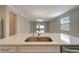 Kitchen island with double sink overlooks living room at 16820 Anchor Root St, Wimauma, FL 33598
