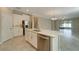 Modern kitchen with island, stainless steel appliances, and light-colored cabinetry at 16820 Anchor Root St, Wimauma, FL 33598