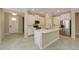 Modern kitchen with white cabinets, island, and stainless steel appliances at 16820 Anchor Root St, Wimauma, FL 33598