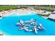 Aerial view of crystal-clear lagoon with inflatable water park at 16820 Anchor Root St, Wimauma, FL 33598