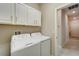 Laundry room with washer, dryer, and upper cabinets at 16820 Anchor Root St, Wimauma, FL 33598