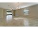 Bright living room featuring tile floors and access to backyard at 16820 Anchor Root St, Wimauma, FL 33598