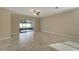 Living room with tile floors and sliding glass doors at 16820 Anchor Root St, Wimauma, FL 33598