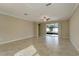 Open living area with tile floors and access to patio at 16820 Anchor Root St, Wimauma, FL 33598