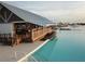 Beach entry pool and adjacent clubhouse with a deck at 16820 Anchor Root St, Wimauma, FL 33598