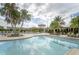 Resort-style pool with palm trees and lounge chairs at 16820 Anchor Root St, Wimauma, FL 33598