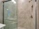 Walk-in shower with glass enclosure and tiled walls at 16820 Anchor Root St, Wimauma, FL 33598