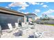 Outdoor entertaining space with fire pit, seating, and a screened enclosure at 21680 Violet Periwinkle Dr, Land O Lakes, FL 34637