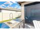 Stainless steel outdoor kitchen with grill and sink at 21680 Violet Periwinkle Dr, Land O Lakes, FL 34637