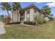 Condo building with lush landscaping and palm trees at 2750 E Bay Dr # 15E, Largo, FL 33771
