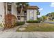Inviting condo exterior, featuring landscaping and a private entrance at 2750 E Bay Dr # 15E, Largo, FL 33771