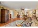 Open living space with hardwood floors, comfortable seating, and views to dining area at 2750 E Bay Dr # 15E, Largo, FL 33771