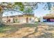 Tan house with carport and landscaping at 2930 Feather Dr, Clearwater, FL 33759