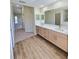 Double vanity bathroom with a large mirror and beige wood cabinets at 295 Woodstream Way, Spring Hill, FL 34608