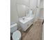 Bathroom with a single vanity, white cabinets, and a large mirror at 295 Woodstream Way, Spring Hill, FL 34608
