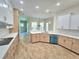 Open-concept kitchen with island and stainless steel appliances at 295 Woodstream Way, Spring Hill, FL 34608